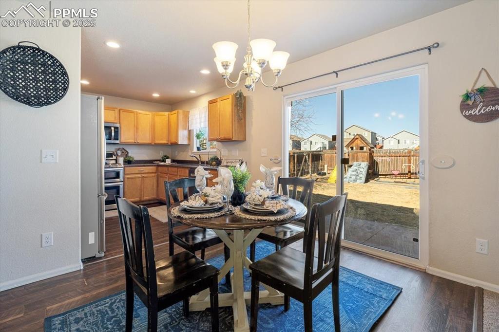 13038 Devil's Thumb Place Peyton, CO 80831 - Photo 7 of 44 The dining area has convenient garage access, a slider to the backyard, and seamlessly connects to the kitchen.