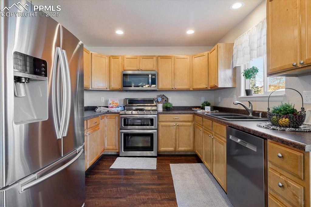 13038 Devil's Thumb Place Peyton, CO 80831 - Photo 8 of 44 The Kitchen is equipped with ample wood cabinetry, generous counter space, a pantry closet, and stainless steel appliances.