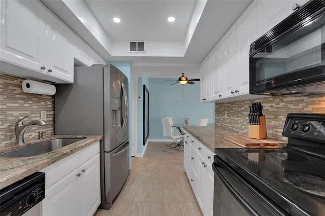 a kitchen with stainless steel appliances and a counter space