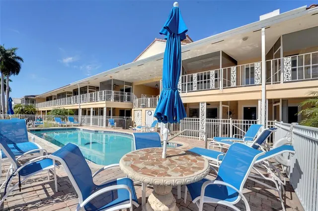 a view of a house with swimming pool and sitting area