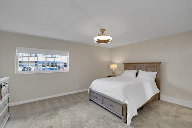 a bedroom with a bed and a night stand