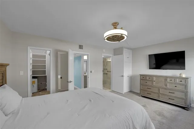 a bedroom with a bed and cabinets