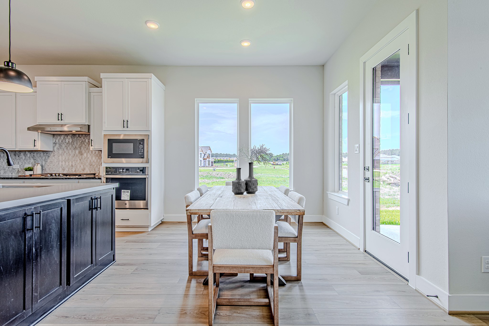 141 Peninsula Point Drive Montgomery, TX 77356 - Photo 13 of 47 Enjoy your morning coffee with a view—this cozy dining space is bathed in natural light and framed by picture windows overlooking the greenbelt.