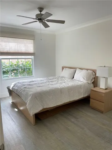 a bedroom with a bed and large window