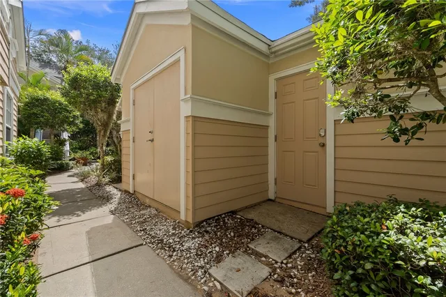 a view of small house with a backyard