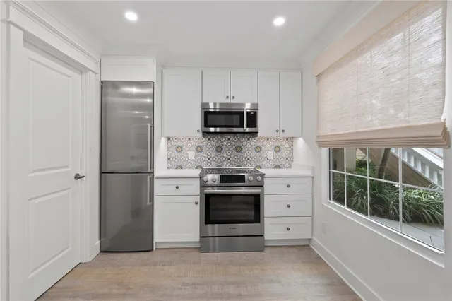 a kitchen with a stove and a refrigerator