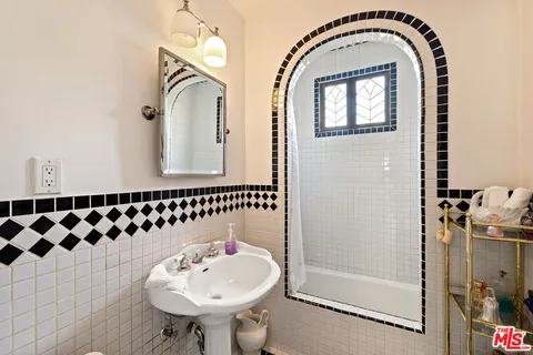 a bathroom with a sink a mirror and shower