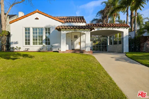 a view of a house with a swimming pool and porch with furniture