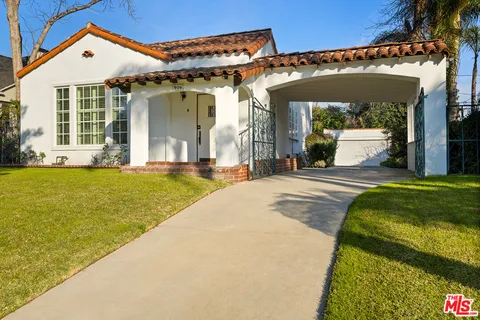 a front view of a house with a yard table and chairs