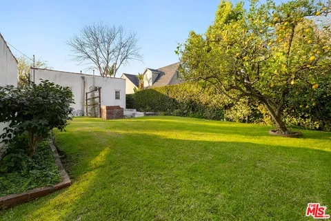 a view of a house with a large tree