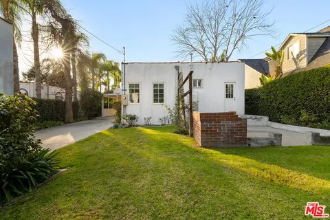 a view of a house with a yard and garage
