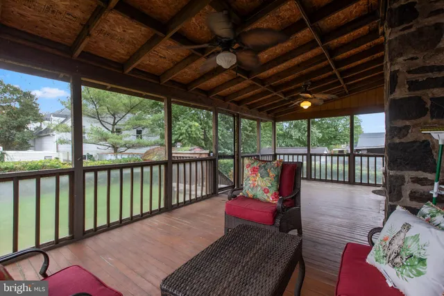 a roof deck with couch and chairs