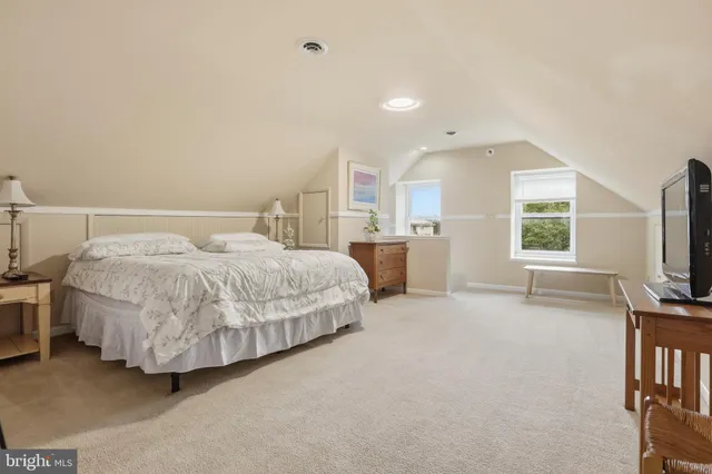 a spacious bedroom with a bed and a table in it