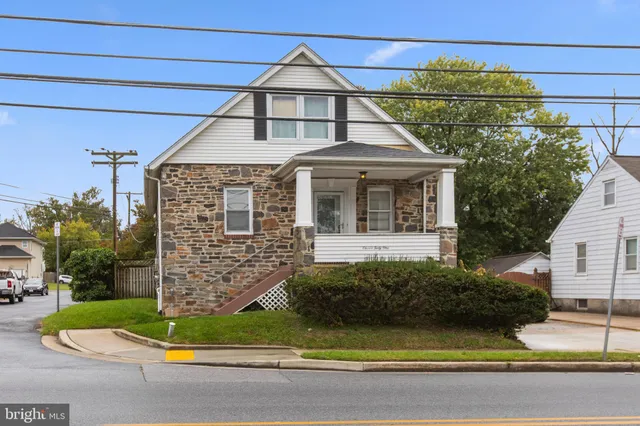 a front view of a house with a garden and plants