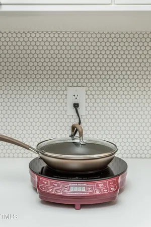 a toilet sitting on top of a white wall