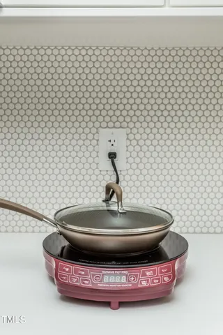 a toilet sitting on top of a white wall