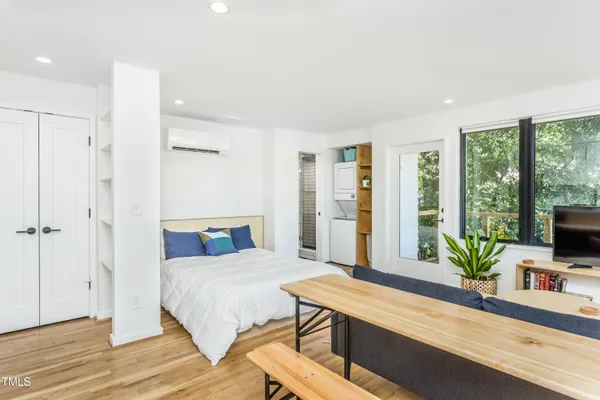 a bedroom with a bed and large window