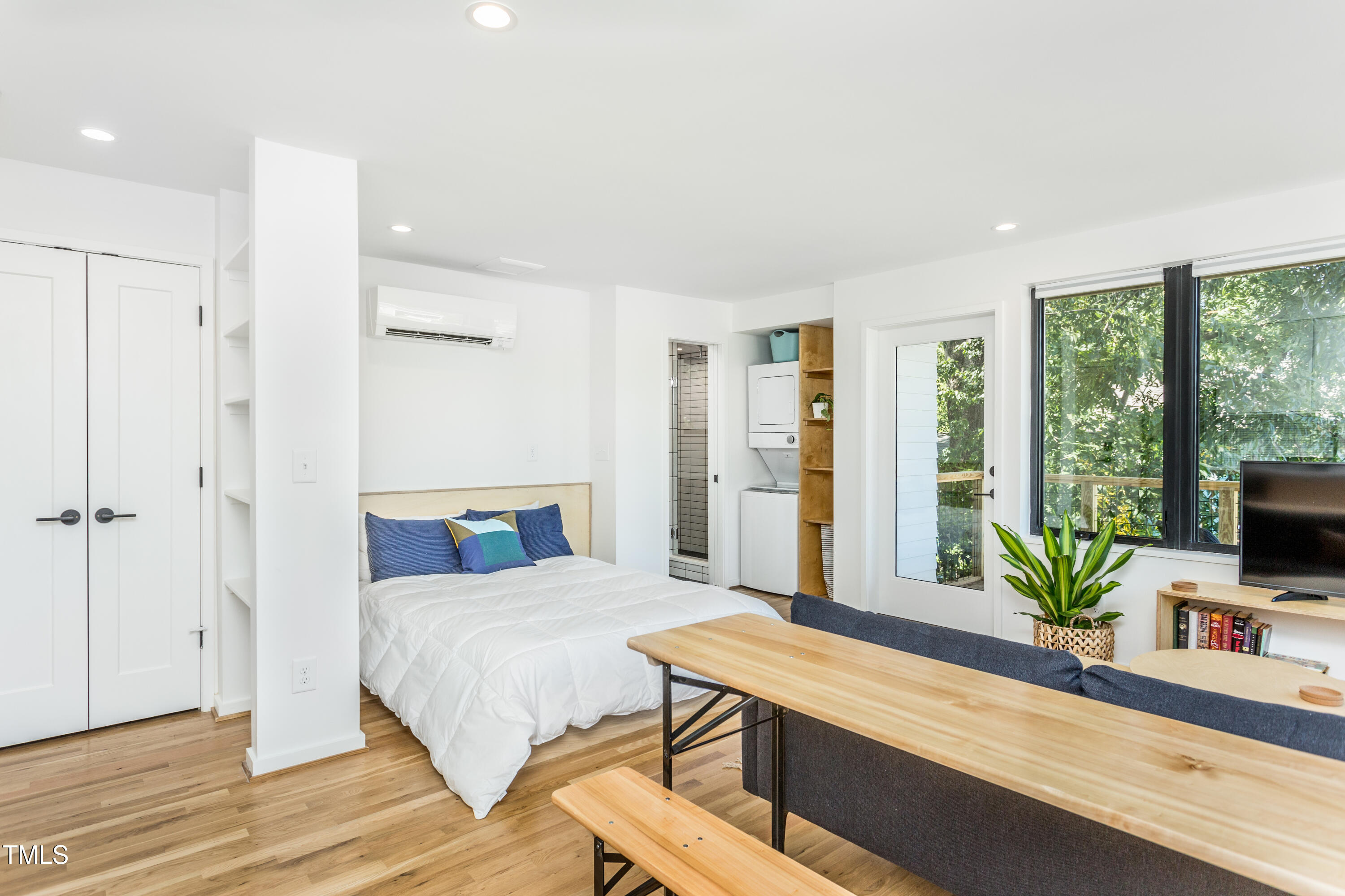 123 Idlewild Avenue, Unit 202 Raleigh, NC 27601 - Photo 8 of 20 a bedroom with a bed and large window
