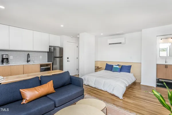 a bedroom with a bed couch and a window