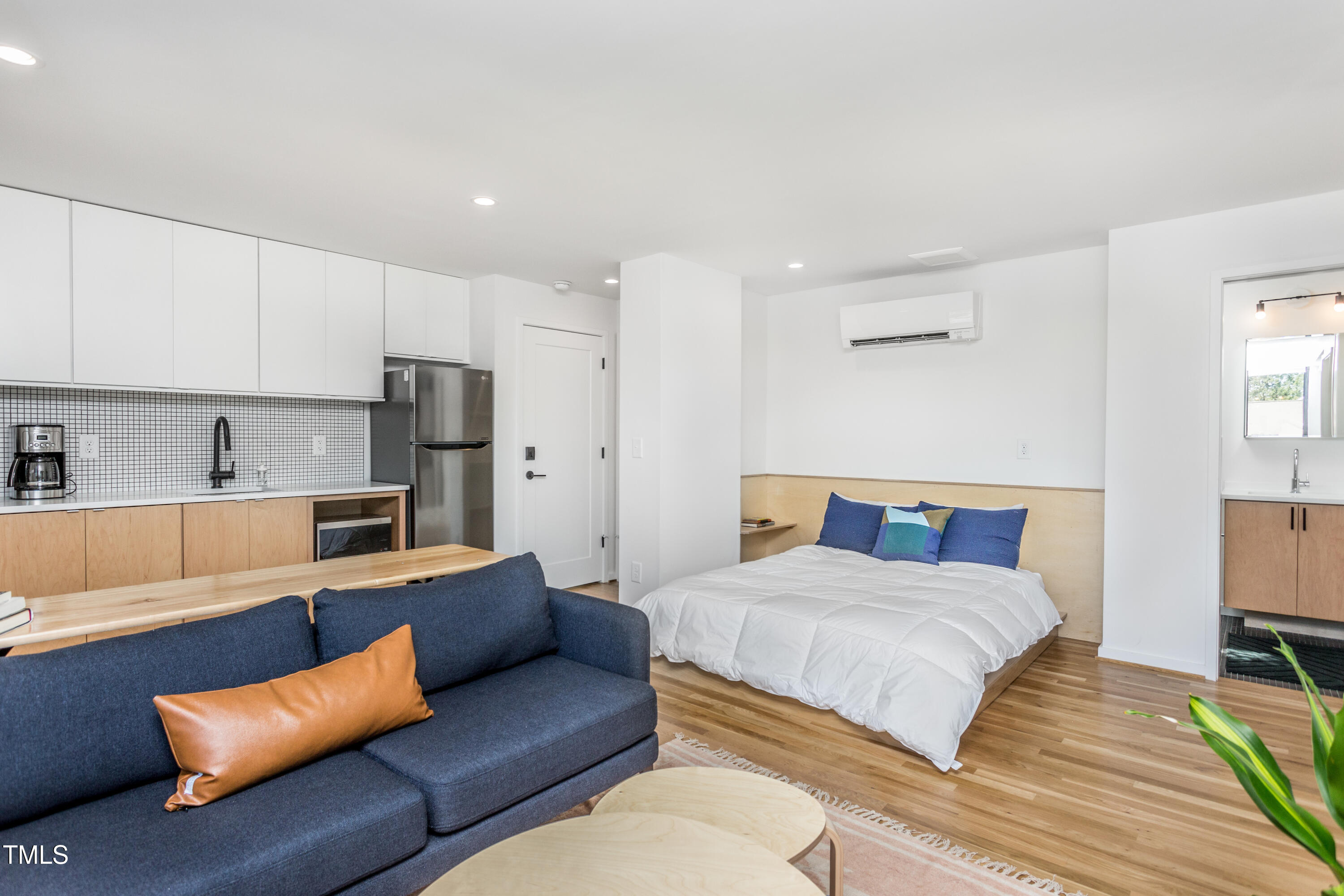 123 Idlewild Avenue, Unit 202 Raleigh, NC 27601 - Photo 10 of 20 a bedroom with a bed couch and a window