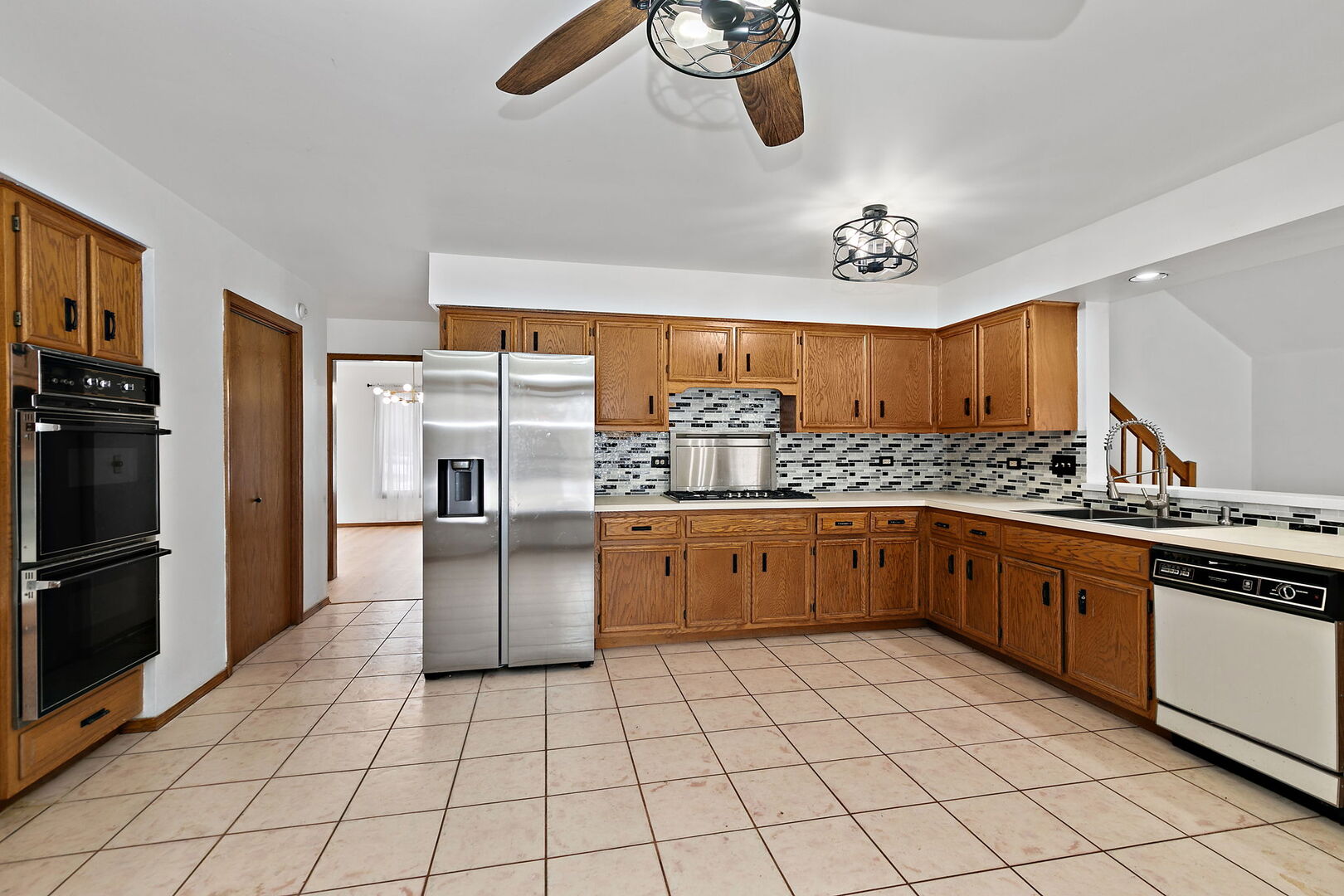 1874 Ranchview Drive Naperville, IL 60565 - Photo 5 of 21 a kitchen with stainless steel appliances a refrigerator sink and cabinets