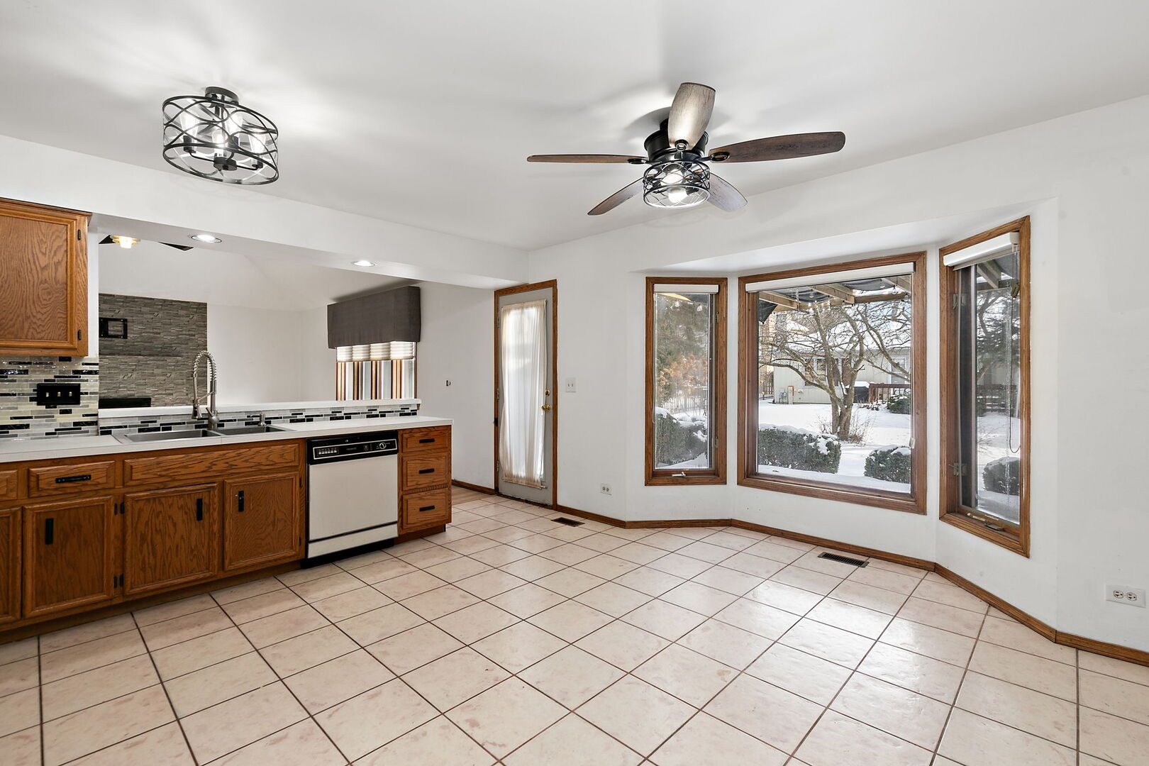 1874 Ranchview Drive Naperville, IL 60565 - Photo 6 of 21 a large white kitchen with granite countertop a large window
