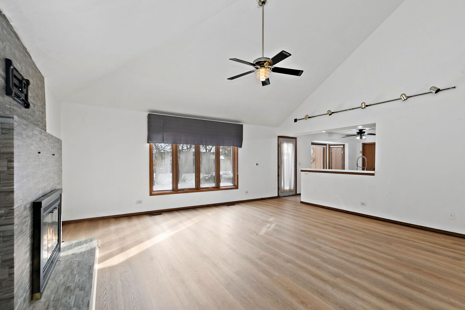 1874 Ranchview Drive Naperville, IL 60565 - Photo 8 of 21 a view of an empty room with window and wooden floor