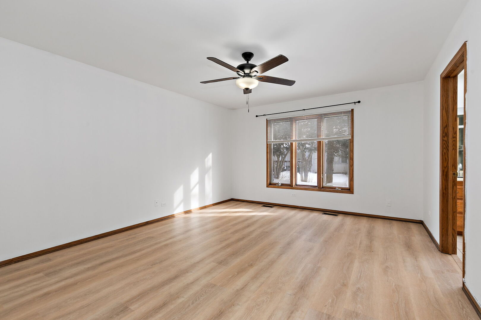 1874 Ranchview Drive Naperville, IL 60565 - Photo 10 of 21 a view of an empty room with a window and wooden floor