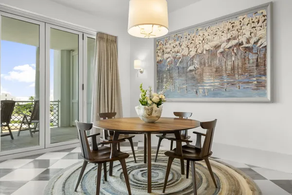 a large white bed in a room next to a window