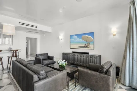 a view of a small space with wooden floor and windows