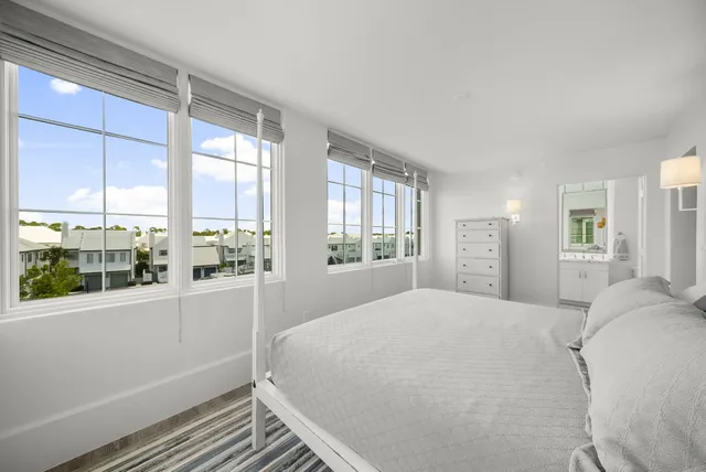 a living room with a couch and windows