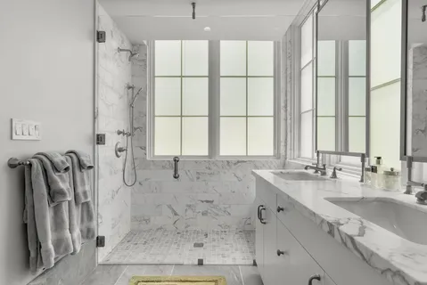 a bathroom with a glass shower door