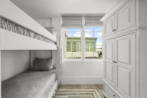 a view of a patio with table and chairs with wooden floor and fence