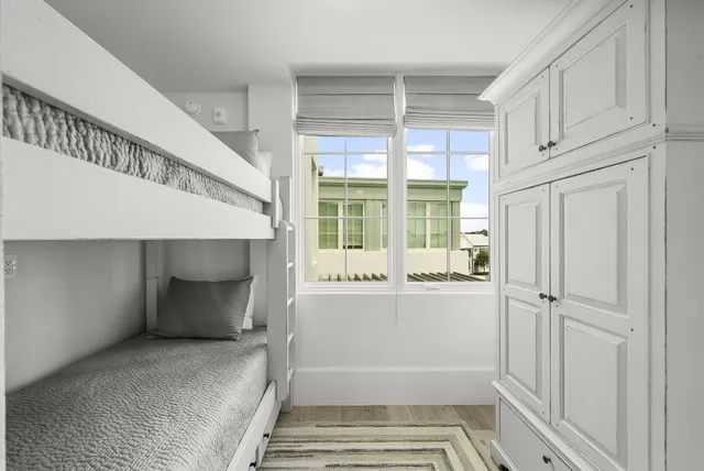 a view of a patio with table and chairs with wooden floor and fence