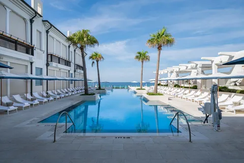a view of a house with a swimming pool and a yard