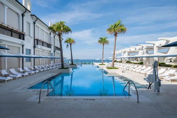 a view of a house with a swimming pool and a yard