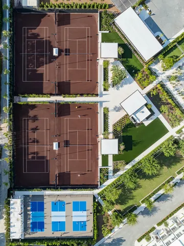 a front view of multi story residential apartment building with yard and sign board