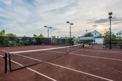 a view of a house with sitting area and garden