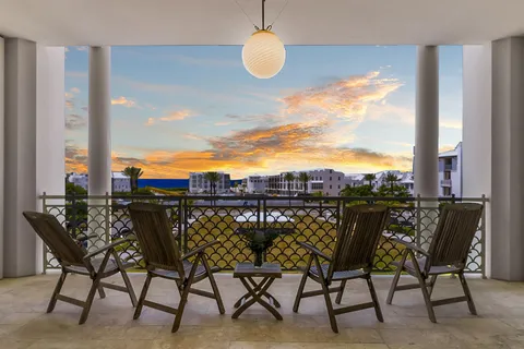 a kitchen with stainless steel appliances a stove a table and chairs