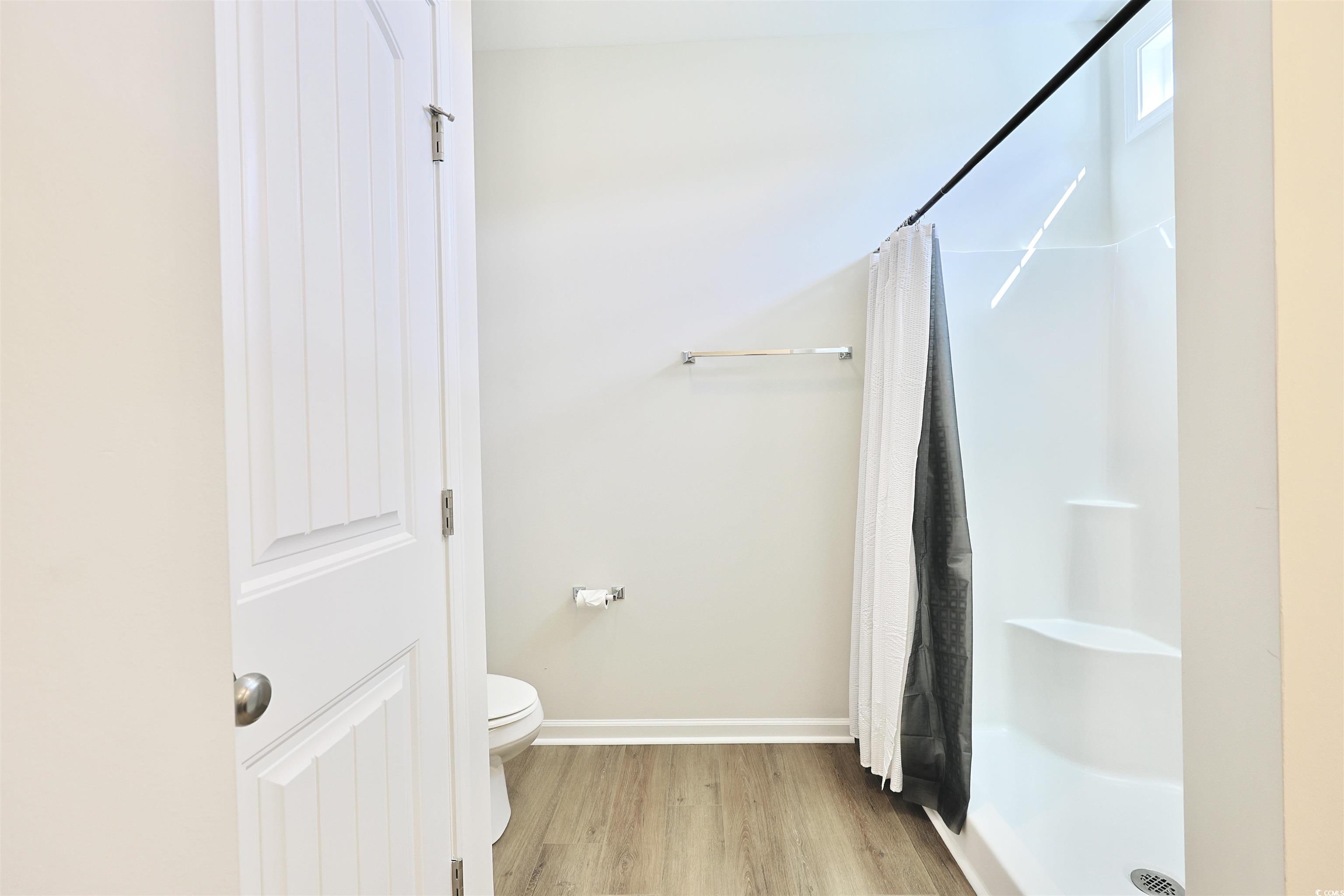 266 Ole Maple Street Loris, SC 29569 - Photo 15 of 30 Full bathroom with wood finished floors and a shower with curtain