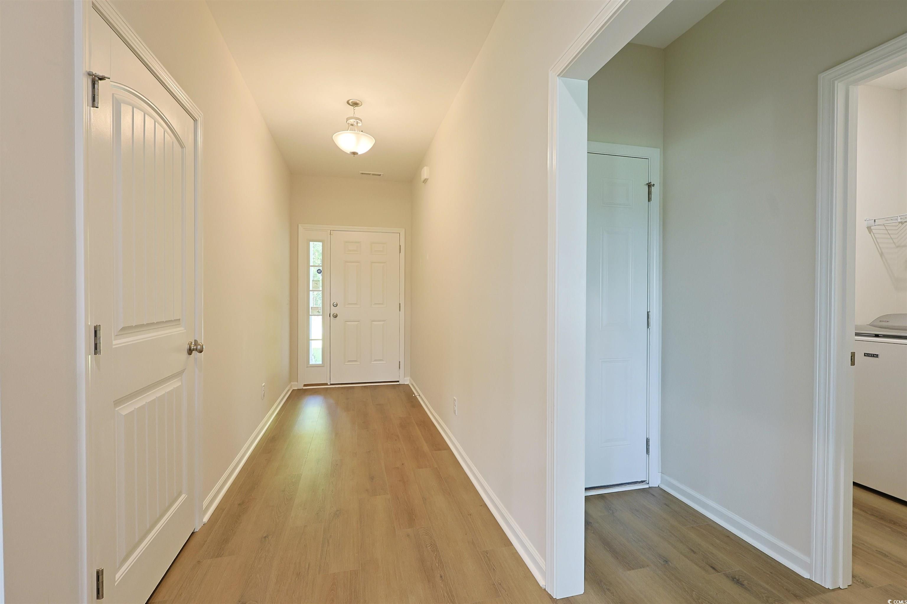266 Ole Maple Street Loris, SC 29569 - Photo 16 of 30 Hallway featuring light wood-style floors and washer / clothes dryer