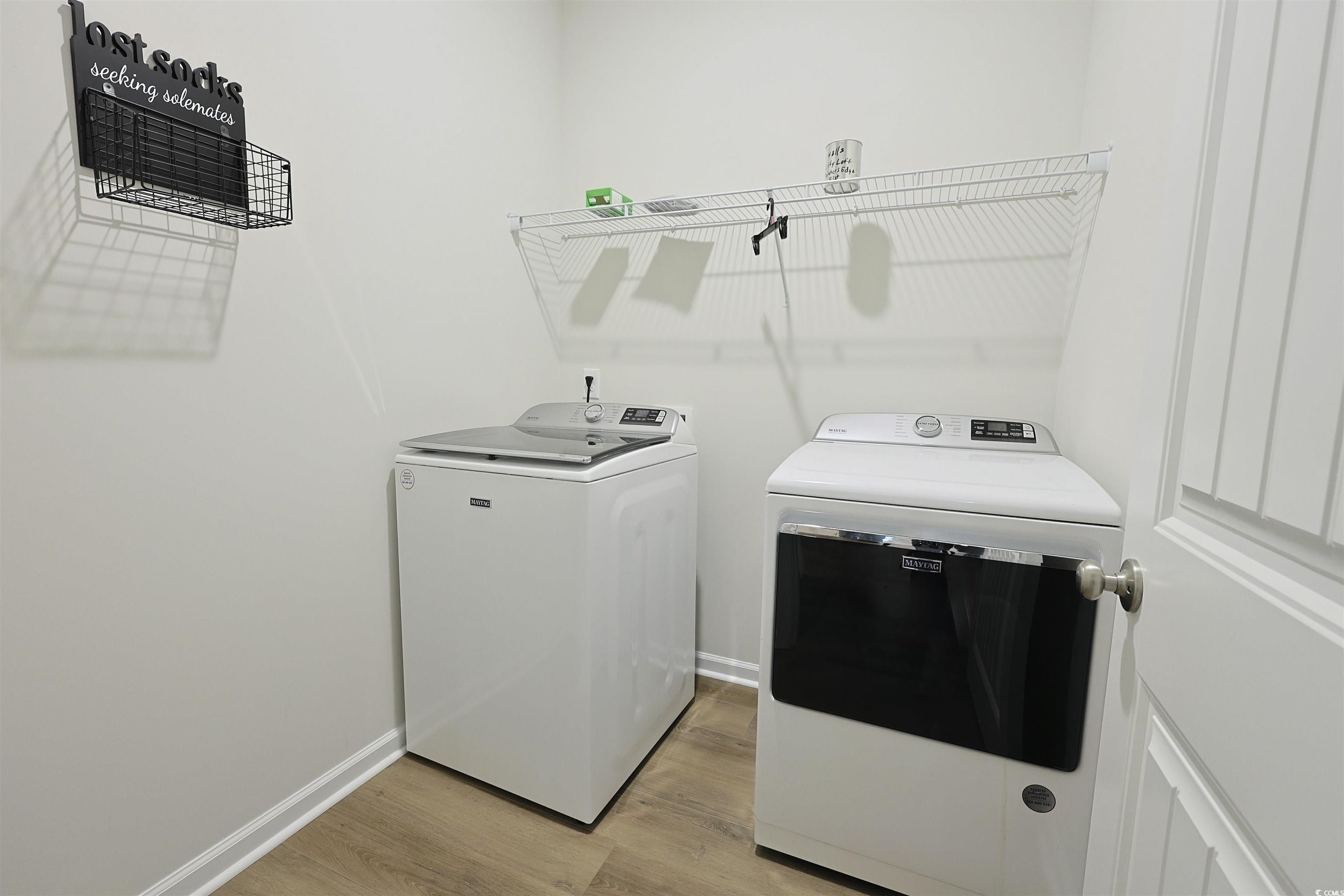 266 Ole Maple Street Loris, SC 29569 - Photo 17 of 30 Laundry room with washing machine and dryer and light wood-style flooring