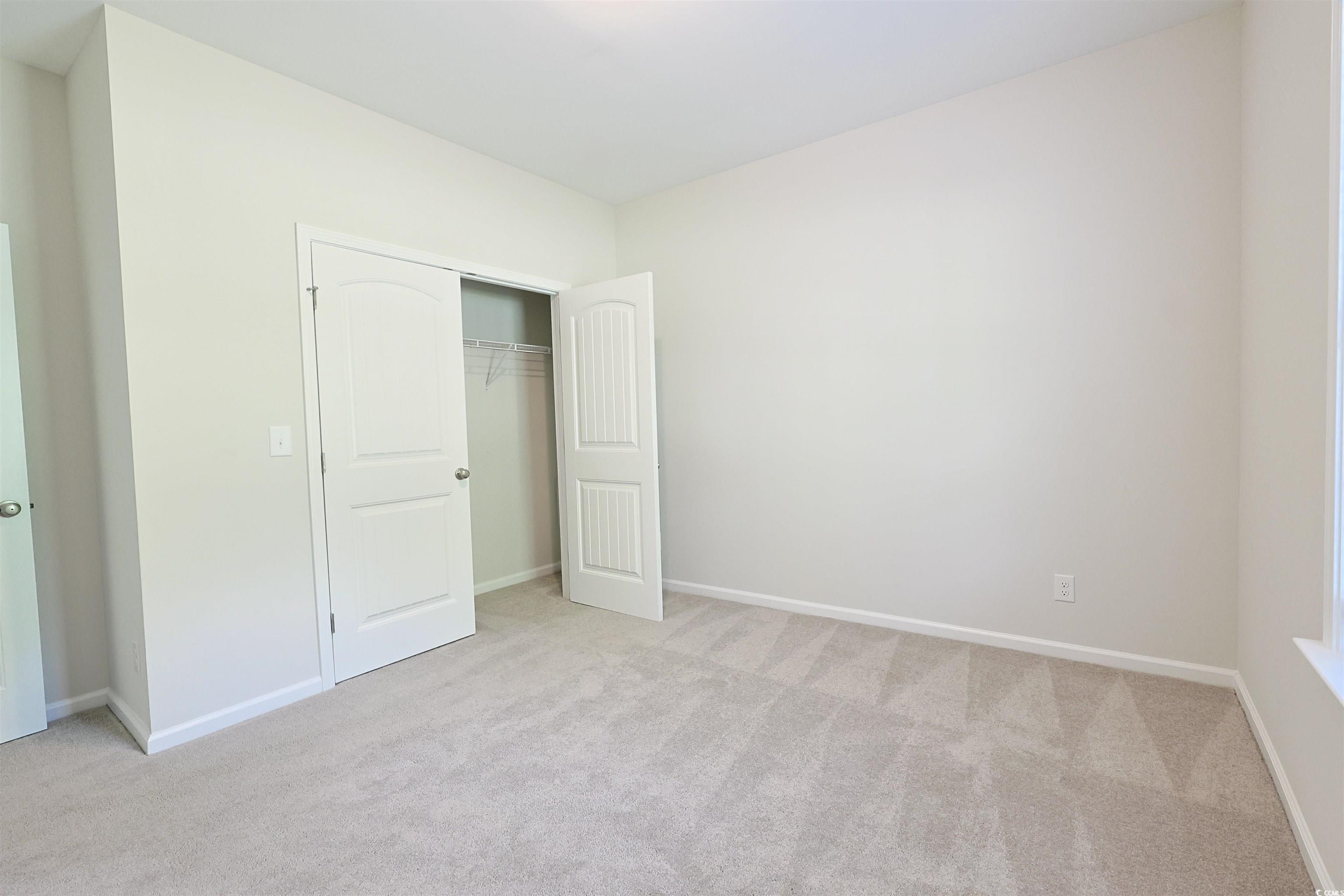266 Ole Maple Street Loris, SC 29569 - Photo 19 of 30 Unfurnished bedroom featuring light carpet and a closet