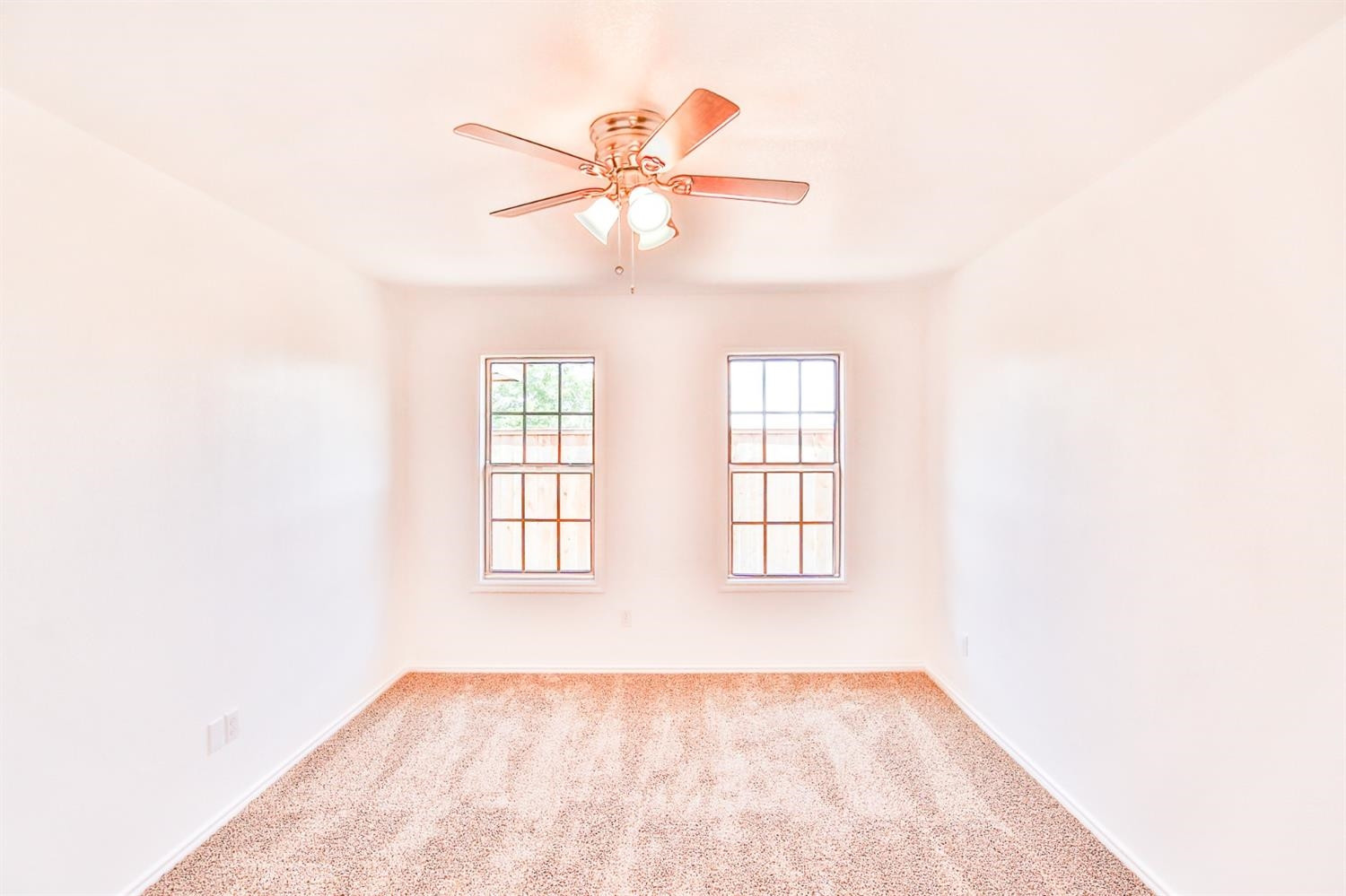 5710 Grinnell Street Lubbock, TX 79416 - Photo 14 of 21 a view of an empty room with wooden floor and a window