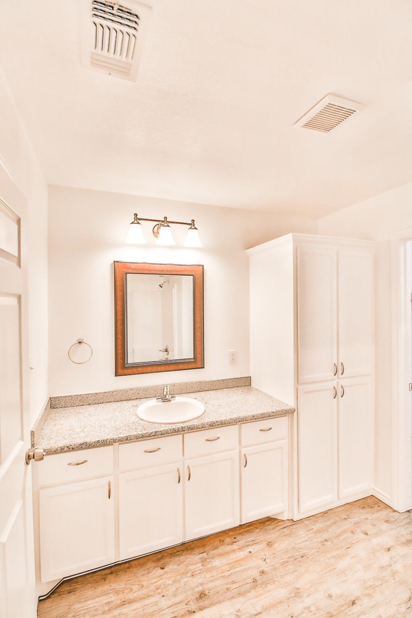 5710 Grinnell Street Lubbock, TX 79416 - Photo 18 of 21 a bathroom with a sink and a mirror