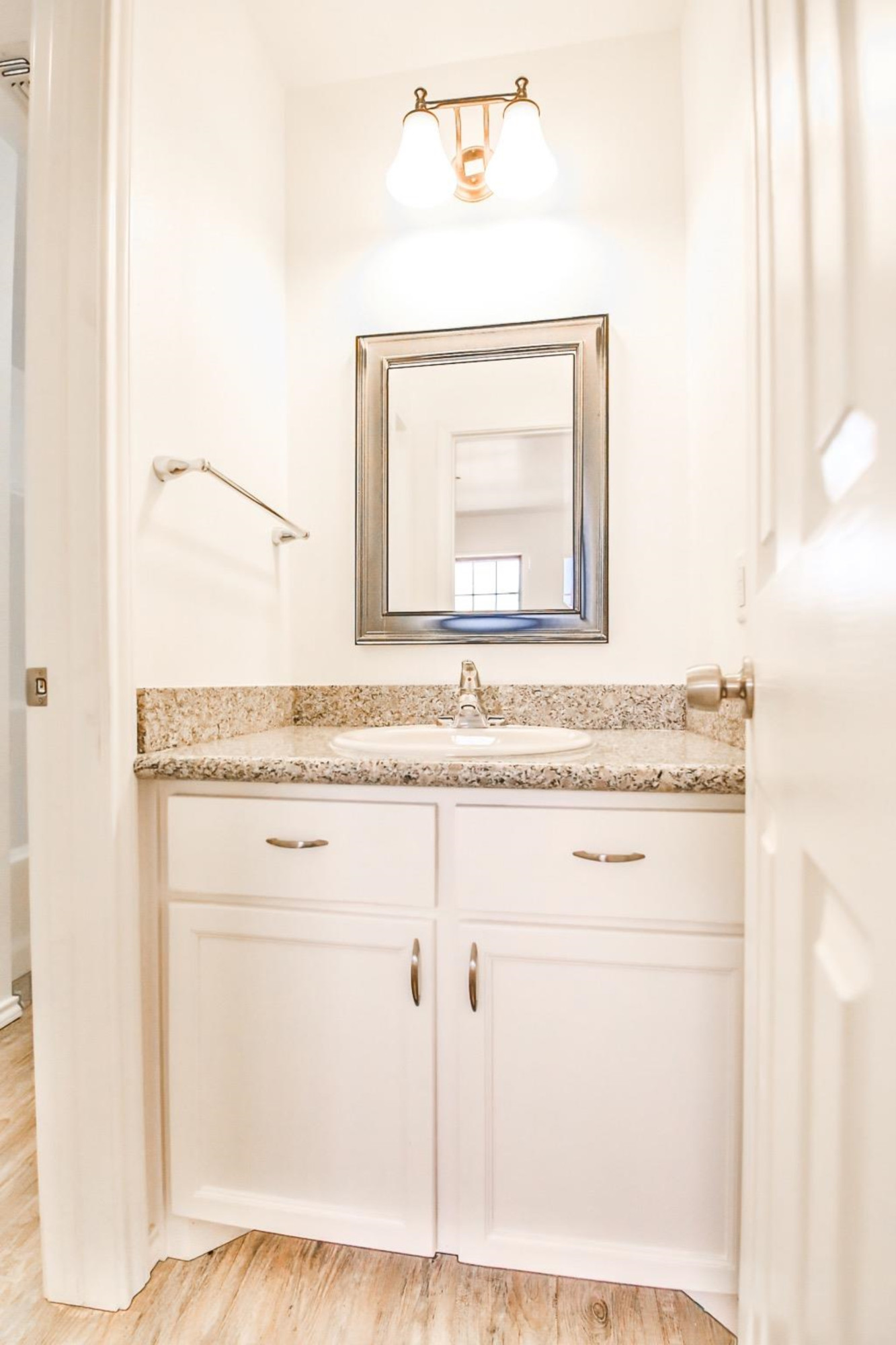 5710 Grinnell Street Lubbock, TX 79416 - Photo 10 of 21 a bathroom with a granite countertop sink and a mirror