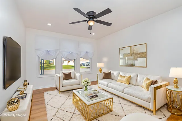 a living room with furniture a window and a flat screen tv