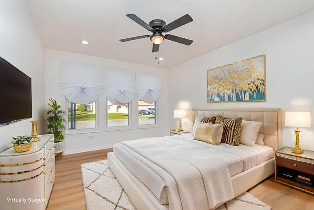 a bedroom with a bed and a large window