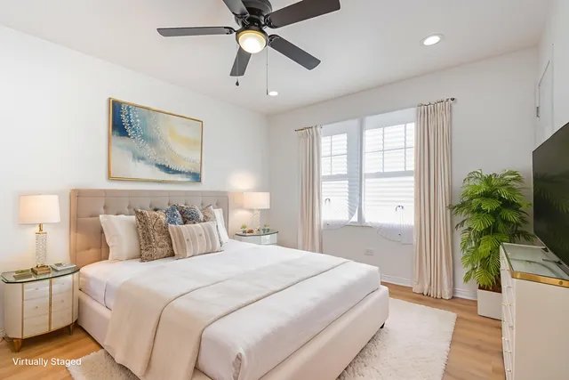 a bedroom with a large bed and a potted plant