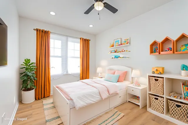 a bedroom with a bed and a potted plant